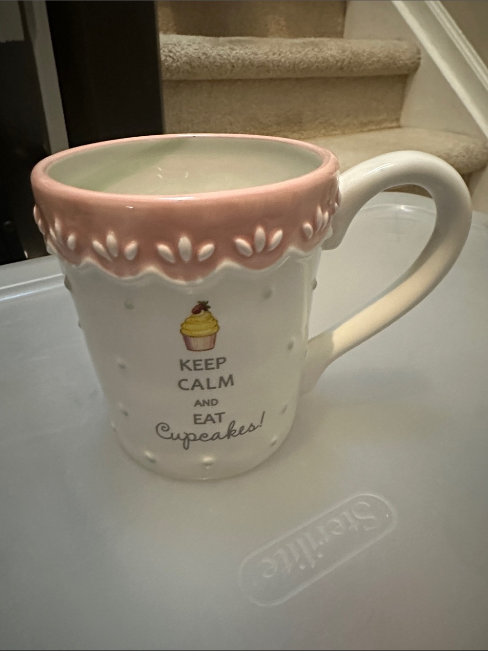 White Ceramic Mug with Pink Trim and Cupcake Graphic